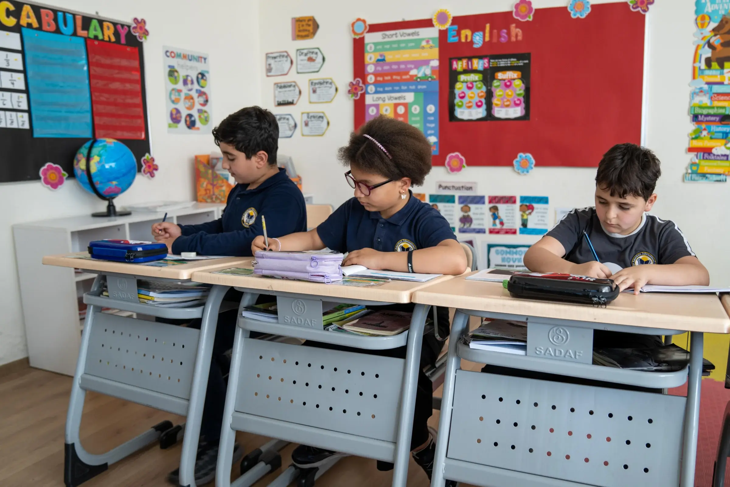 Primary student participating in classroom learning at AIS