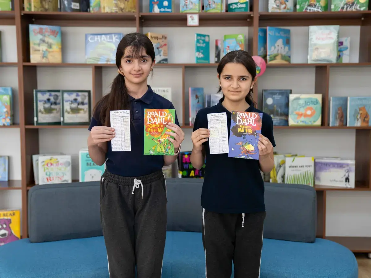 AIS students receiving awards for a reading challenge