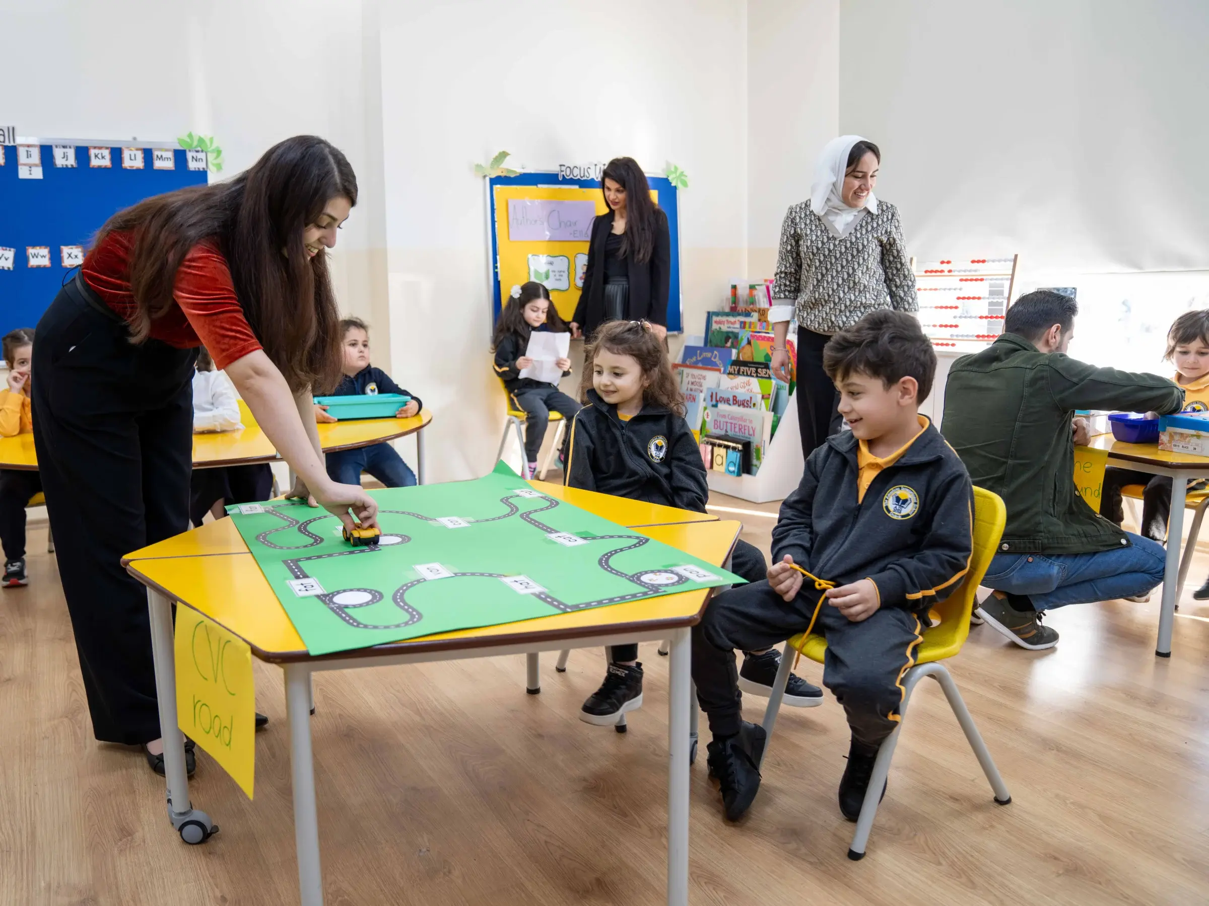 Teacher engaging with AIS students during a science fair activity